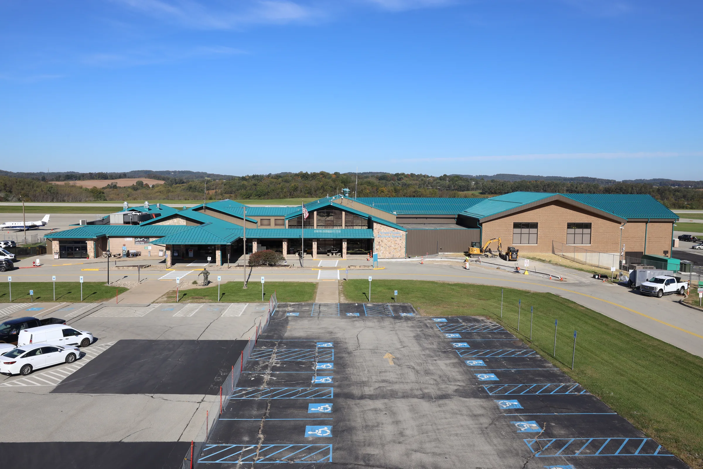 The terminal at Arnold Palmer Regional Airport from above, with the parking lot in front