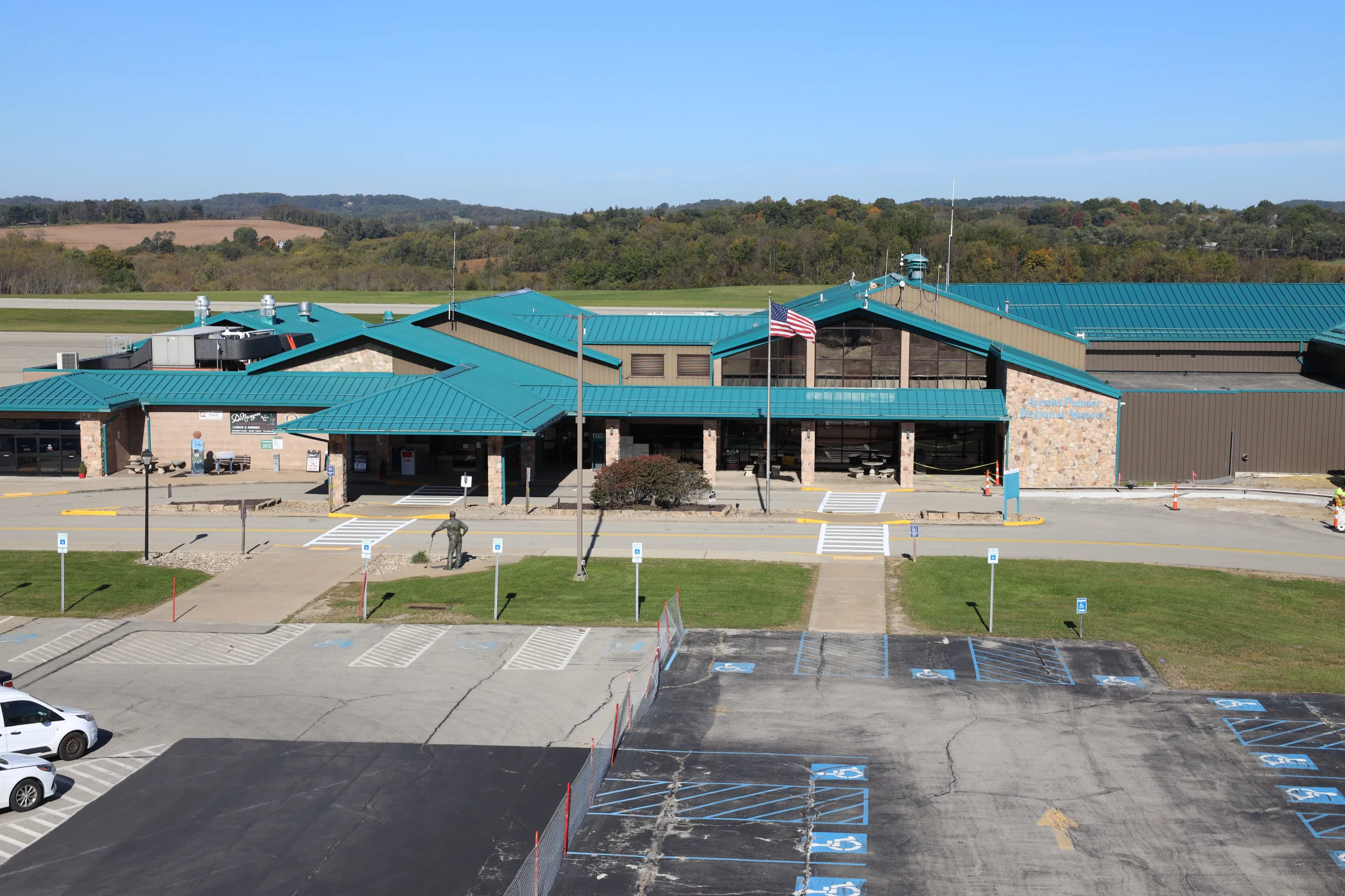 The terminal entrance at Arnold Palmer Regional Airport, with the Arnold Palmer statue out front